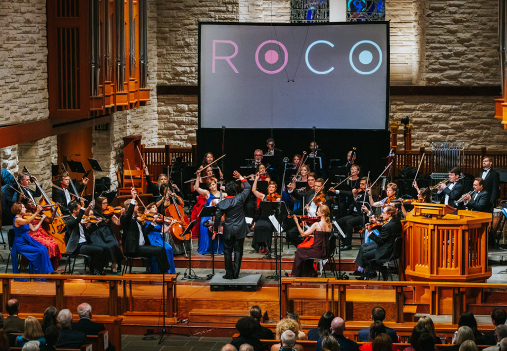The orchestra stands for a standing ovation.