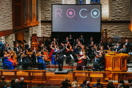 The orchestra stands for a standing ovation.